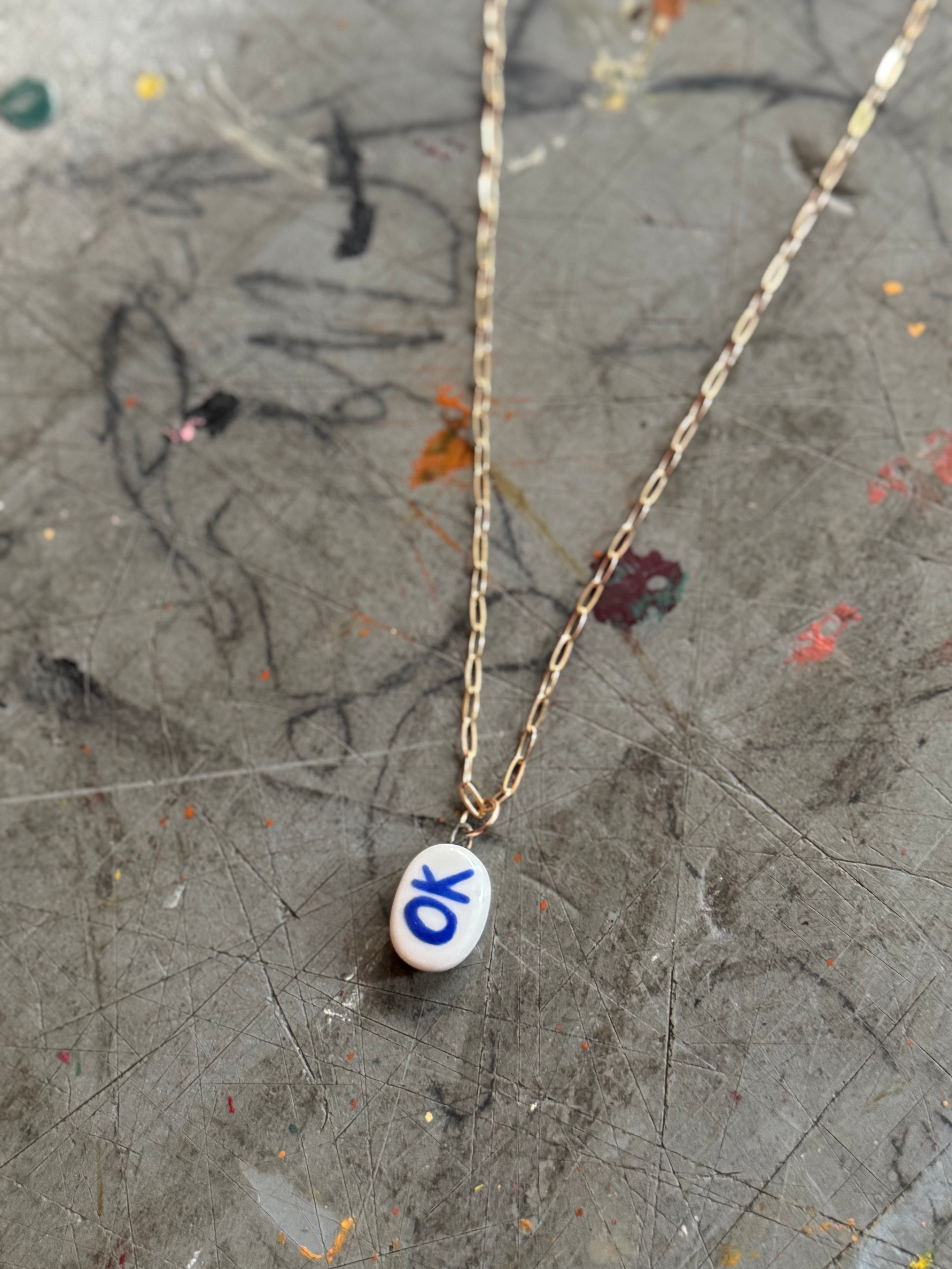 White Porcelain OK Bye Pendant Necklace in 18" Gold Paperclip Chain
