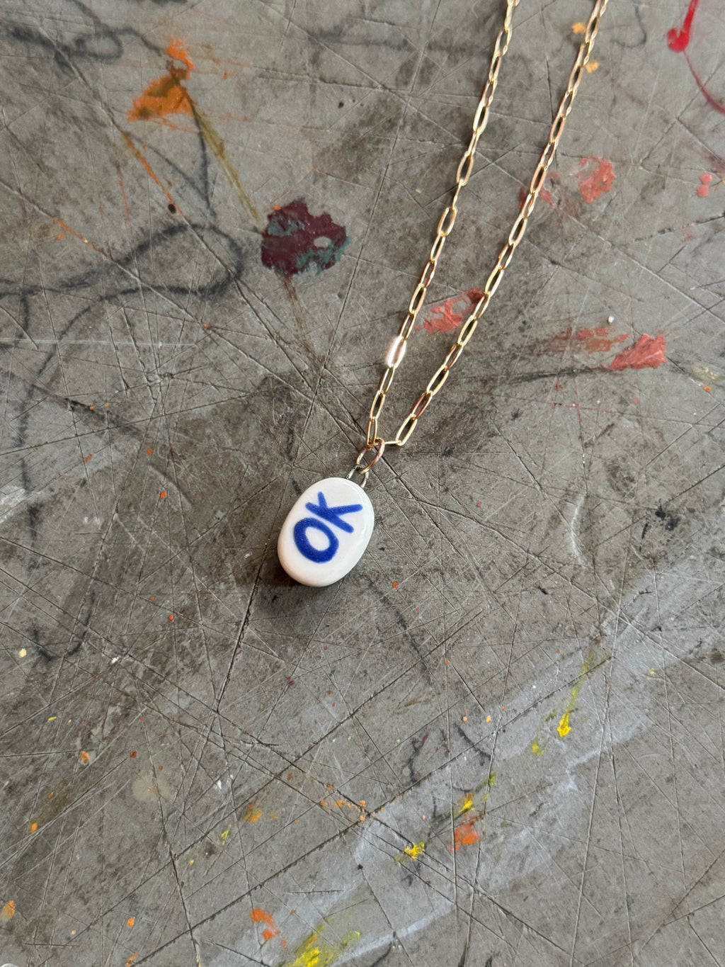 White Porcelain OK Bye Pendant Necklace in 18" Gold Paperclip Chain