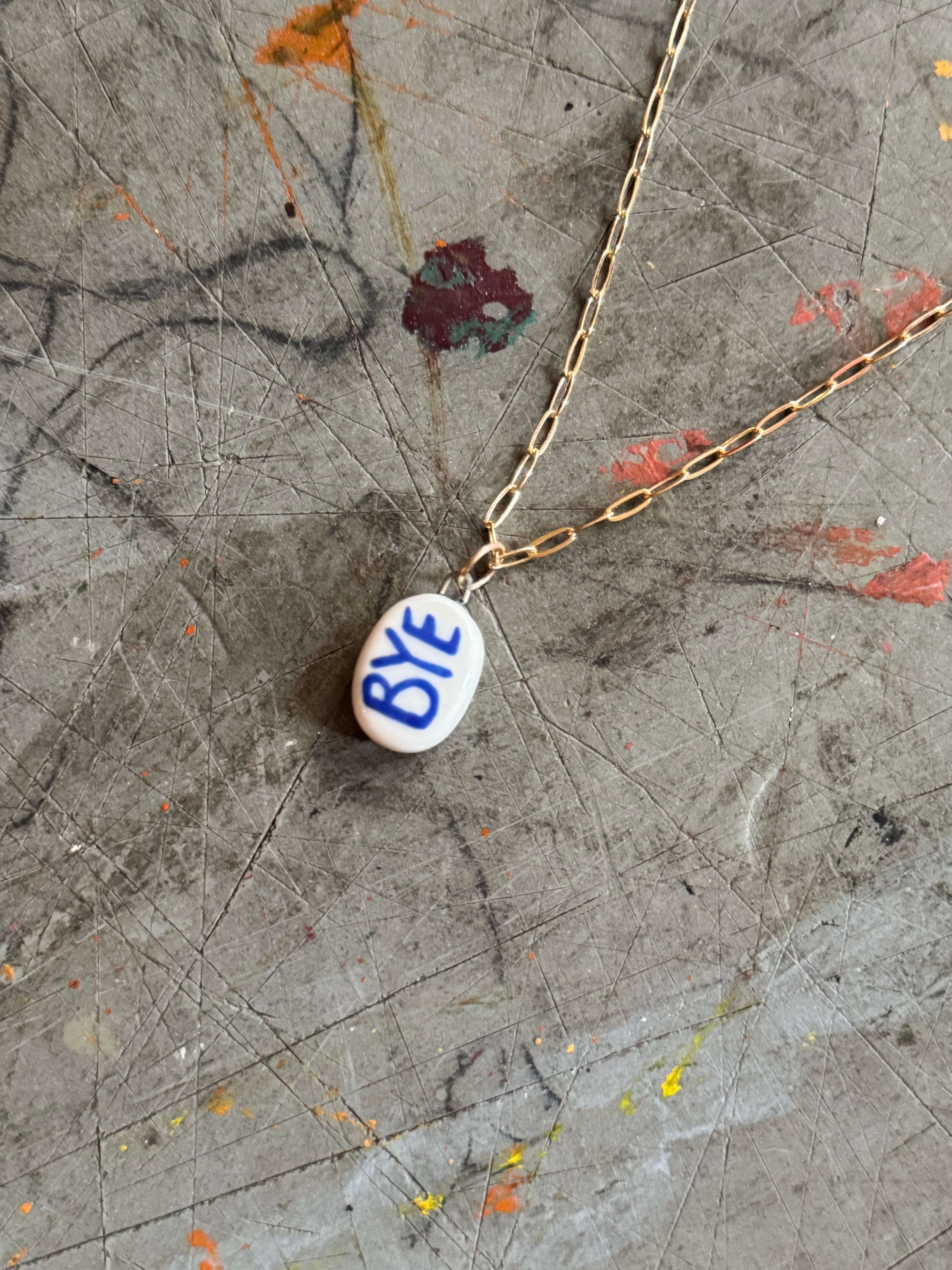 White Porcelain OK Bye Pendant Necklace in 18" Gold Paperclip Chain